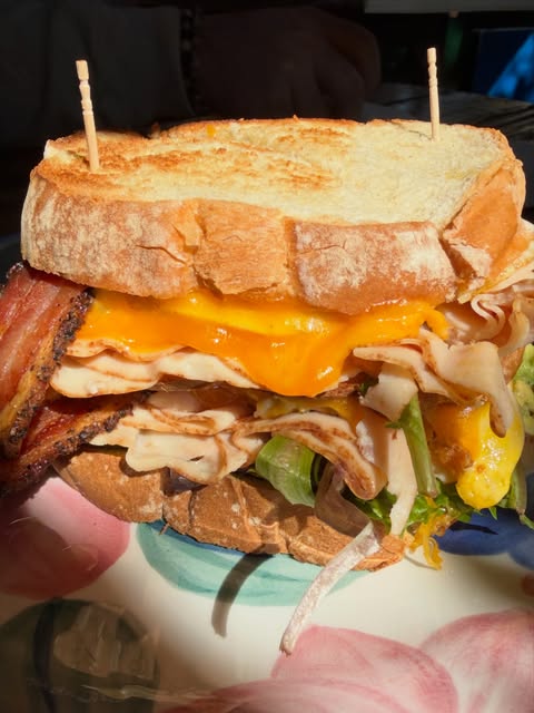 A tall stacked club sandwich made from scratch